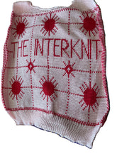 Load image into Gallery viewer, The Interknit Knitted top with red sun patterns and text on a multicolored background
