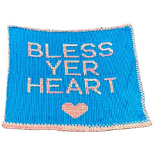 Load image into Gallery viewer, A blue and pink embroidered text 'BLESS YER HEART' on a black chair, with a heart symbol between the words 'BLESS' and 'HEART'.