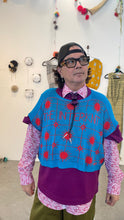 Load image into Gallery viewer, A David Reposar wearing a Turquoise Interknit shirt with a prominent blue and red pattern, standing in Super Fine Art Fair Booth.