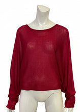 Load image into Gallery viewer, Red sweater on a mannequin with a colorful striped pillow in the background
