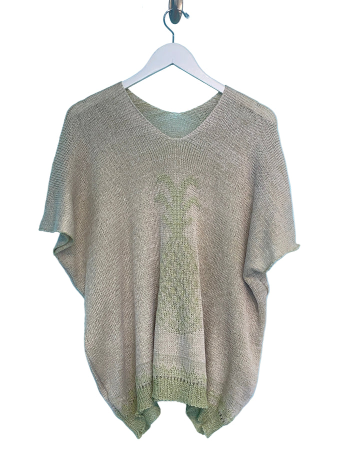 Knitted sweater on a hanger against a blue background