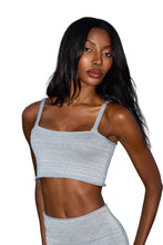 Load image into Gallery viewer, A woman wearing a gray metallic crop tank top with adjustable spaghetti straps
